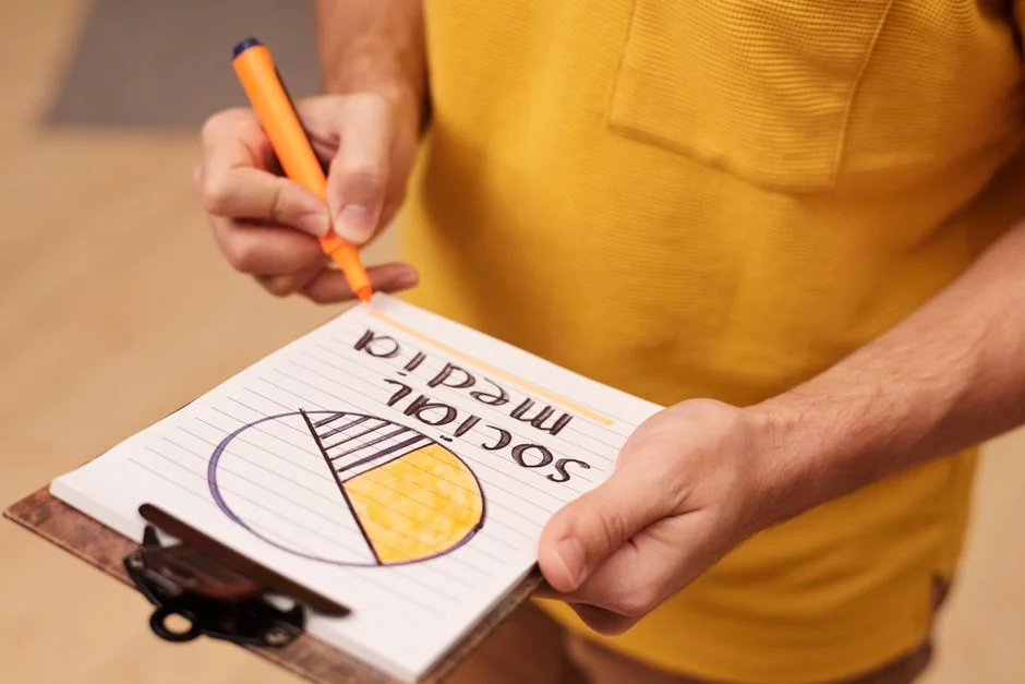 A woman organizing notes on a whiteboard with colorful sticky notes in an office setting.